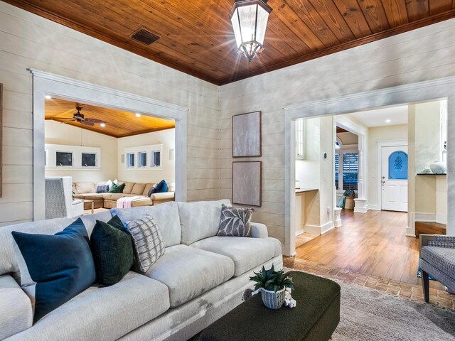 8871 Fishermens Bay Dr, Sarasota, FL 34231 - living area with ornamental molding, wooden ceiling, and wood finished floors