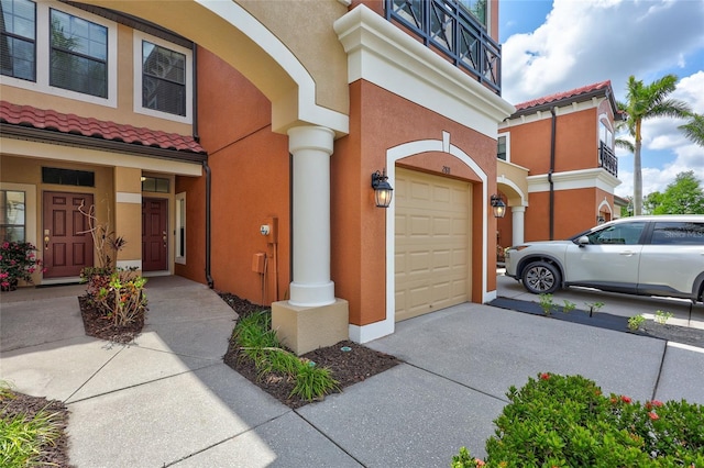 288 Crew Ct, Sarasota, FL 34243 - entrance to property with a garage, stucco siding, and driveway