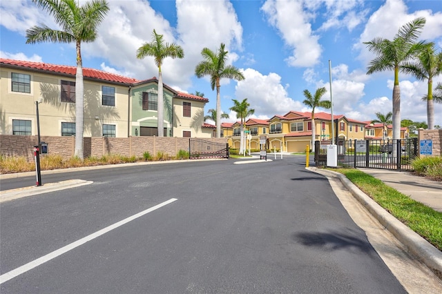288 Crew Ct, Sarasota, FL 34243 - view of road featuring curbs, a gated entry, a gate, a residential view, and sidewalks