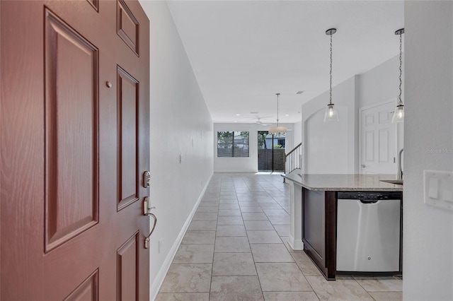 288 Crew Ct, Sarasota, FL 34243 - kitchen featuring light stone countertops, open floor plan, decorative light fixtures, baseboards, and stainless steel dishwasher