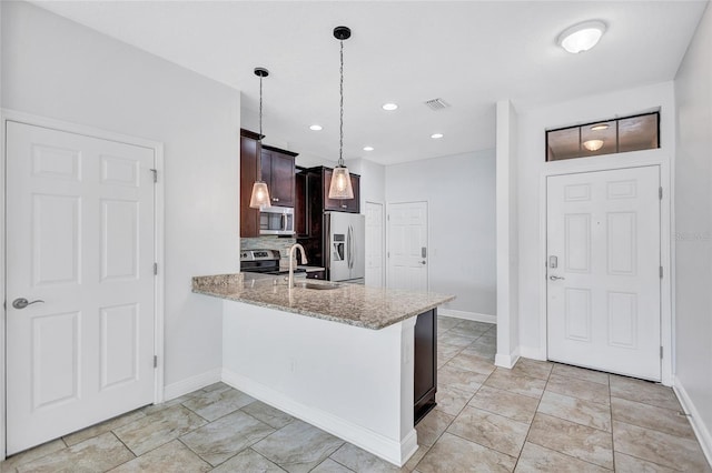 288 Crew Ct, Sarasota, FL 34243 - kitchen with visible vents, light stone countertops, a sink, a peninsula, and stainless steel appliances