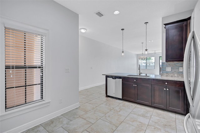 288 Crew Ct, Sarasota, FL 34243 - kitchen featuring a peninsula, dark brown cabinets, a sink, decorative light fixtures, and stainless steel appliances