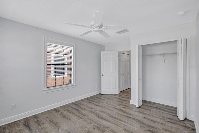 288 Crew Ct, Sarasota, FL 34243 - unfurnished bedroom with baseboards, wood finished floors, visible vents, and a closet