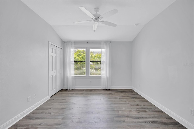 288 Crew Ct, Sarasota, FL 34243 - empty room with baseboards, a ceiling fan, wood finished floors, and lofted ceiling