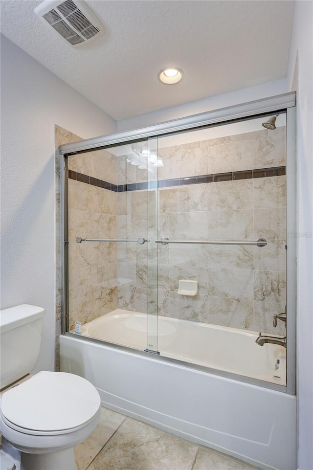 288 Crew Ct, Sarasota, FL 34243 - full bathroom with shower / bath combination with glass door, toilet, visible vents, and a textured ceiling