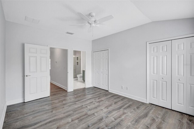 288 Crew Ct, Sarasota, FL 34243 - unfurnished bedroom featuring two closets, baseboards, visible vents, and wood finished floors