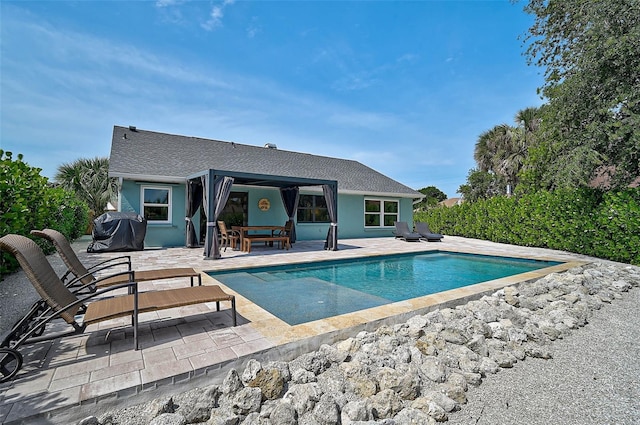 view of pool with a patio area and a grill
