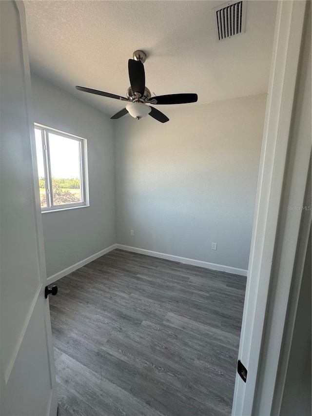 14343 Myakka Ave, Port Charlotte, FL 33953 - unfurnished room featuring dark wood-type flooring, a ceiling fan, visible vents, and baseboards