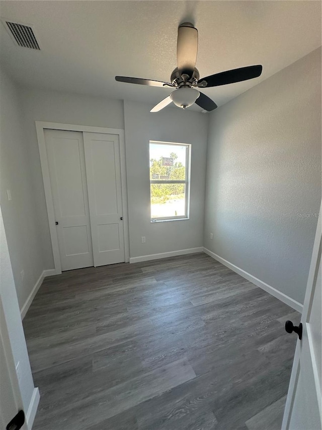 14343 Myakka Ave, Port Charlotte, FL 33953 - unfurnished bedroom with dark wood-style flooring, visible vents, a closet, and baseboards