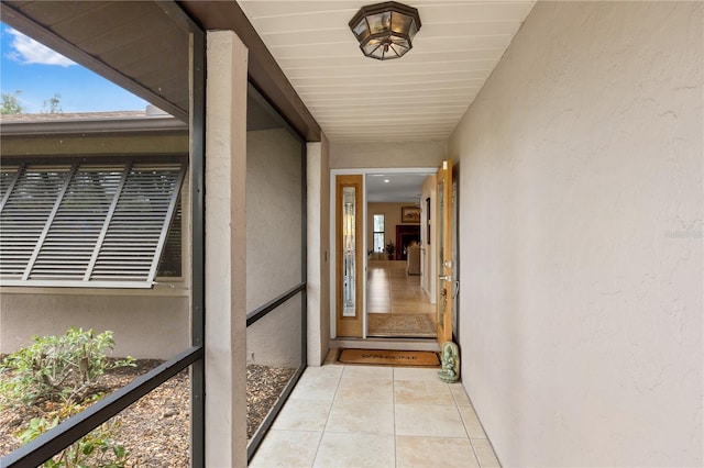 entrance to property featuring stucco siding