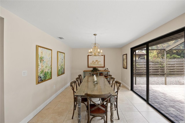dining room featuring visible vents, baseboards, light tile patterned flooring, and an inviting chandelier