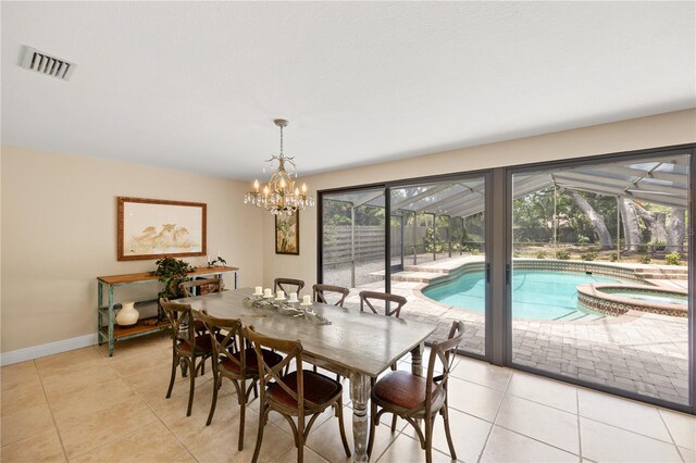 dining room featuring light tile patterned floors, baseboards, a notable chandelier, and visible vents