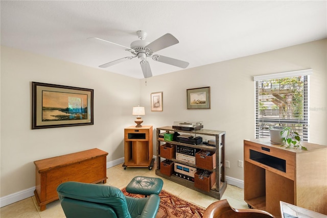 sitting room featuring baseboards and light tile patterned flooring