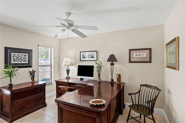 office featuring baseboards, a ceiling fan, and light tile patterned flooring