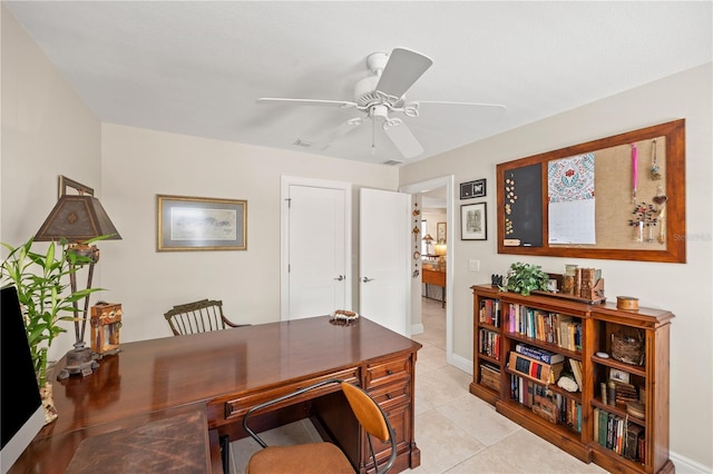 home office with visible vents, baseboards, ceiling fan, and light tile patterned floors