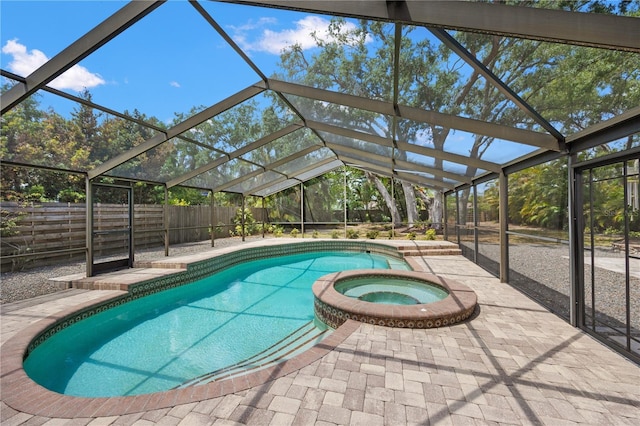 view of pool with a patio, a pool with connected hot tub, a lanai, and a fenced backyard