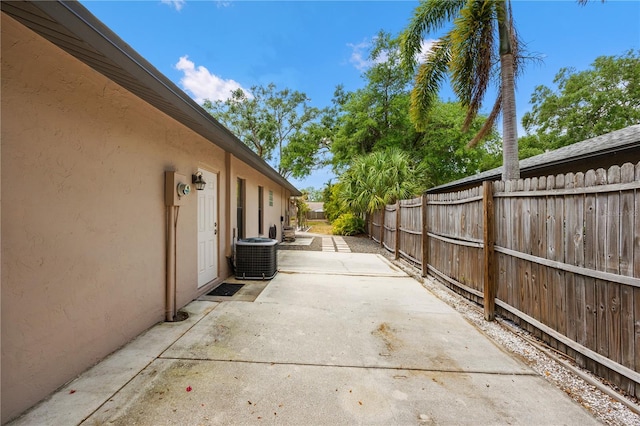 exterior space with central AC and fence