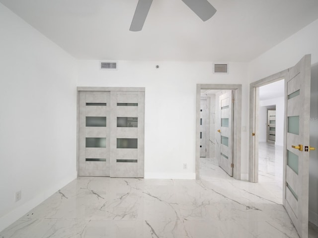 1255 N Gulfstream Ave Unit 402, Sarasota, FL 34236 - unfurnished bedroom with marble tiled flooring, ceiling fan, and baseboards
