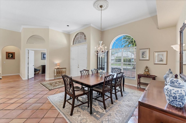 dining room with arched walkways, baseboards, crown molding, light tile patterned floors, and a chandelier
