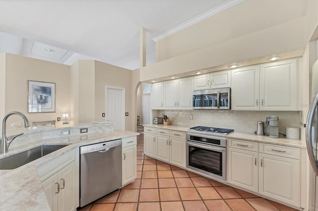 kitchen featuring stainless steel appliances, a sink, decorative backsplash, ornamental molding, and white cabinetry