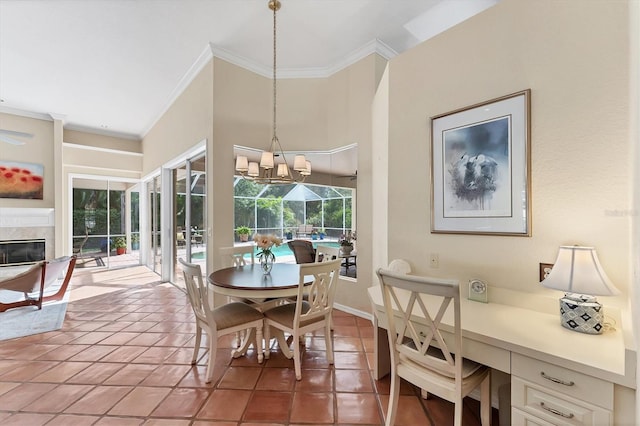 dining area featuring ornamental molding, light tile patterned floors, a chandelier, and a glass covered fireplace