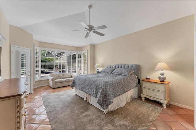 bedroom featuring light tile patterned floors, baseboards, a ceiling fan, and access to exterior