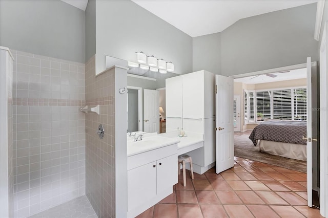 full bath with tile patterned flooring, a walk in shower, vanity, ceiling fan, and high vaulted ceiling