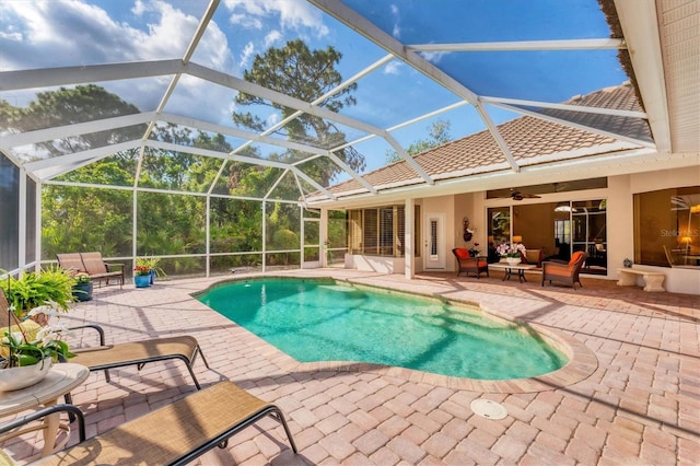 outdoor pool with a patio, a ceiling fan, an outdoor living space, and glass enclosure