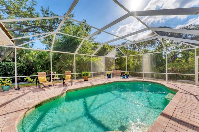 outdoor pool with a patio and a lanai