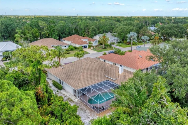aerial view of residential area featuring a heavily wooded area