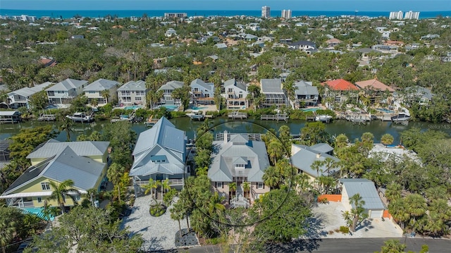 drone / aerial view with a water view and a residential view