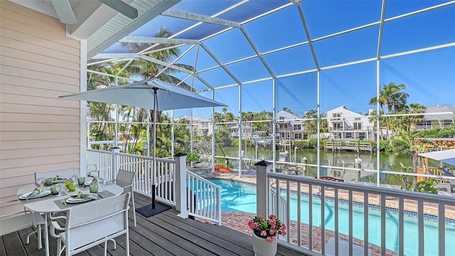 pool featuring glass enclosure and a water view