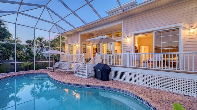 pool with glass enclosure and a patio area