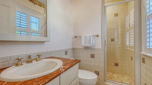 bathroom with tile walls, a healthy amount of sunlight, and a stall shower