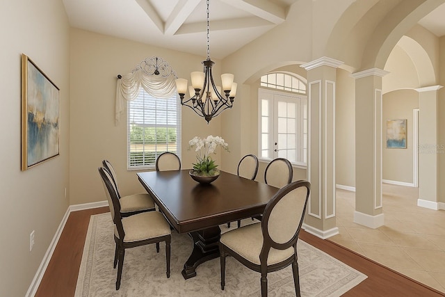15518 29th St E, Parrish, FL 34219 - dining room featuring arched walkways, a chandelier, beamed ceiling, decorative columns, and wood finished floors
