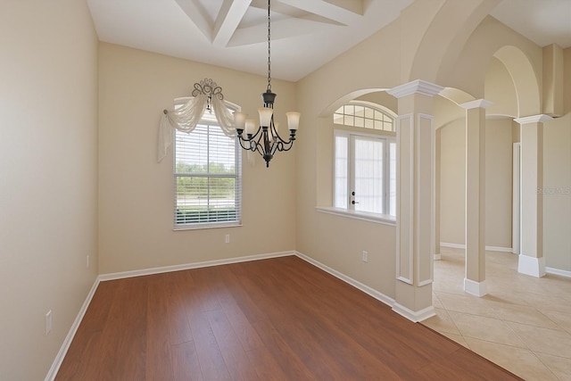 15518 29th St E, Parrish, FL 34219 - unfurnished dining area with decorative columns, a chandelier, wood finished floors, and baseboards