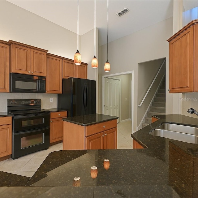 15518 29th St E, Parrish, FL 34219 - kitchen with black appliances, a sink, light tile patterned flooring, pendant lighting, and dark stone counters