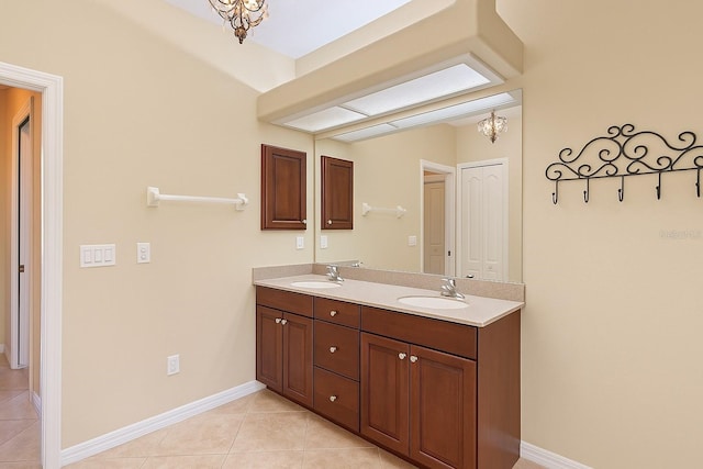 15518 29th St E, Parrish, FL 34219 - bathroom featuring double vanity, tile patterned flooring, a chandelier, and baseboards