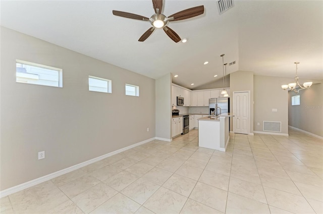 kitchen with appliances with stainless steel finishes, visible vents, open floor plan, vaulted ceiling, and ceiling fan with notable chandelier