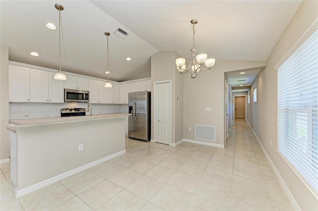 kitchen with lofted ceiling, visible vents, appliances with stainless steel finishes, and light countertops