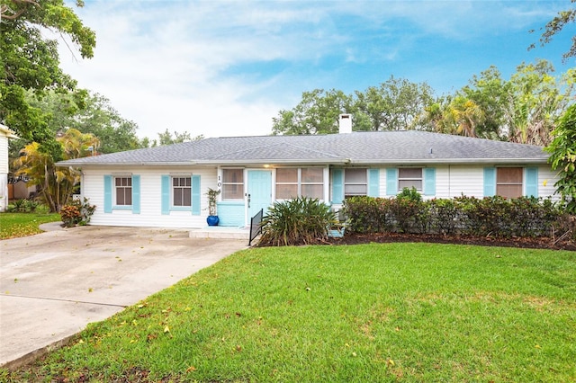 104 Shoreland Dr, Osprey, FL 34229 - ranch-style home featuring a front lawn, a chimney, and concrete driveway