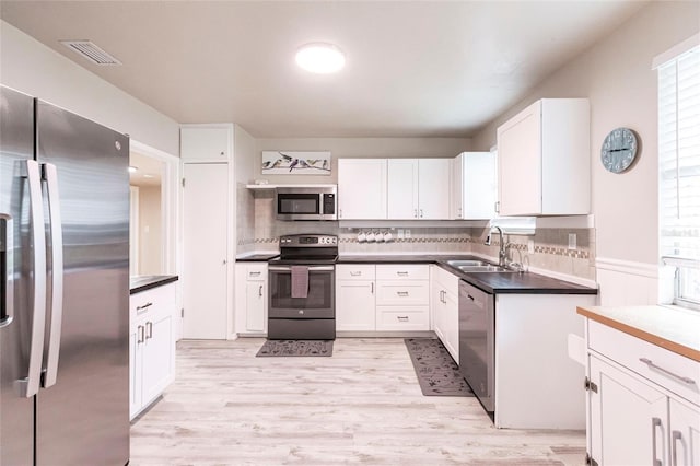 104 Shoreland Dr, Osprey, FL 34229 - kitchen featuring white cabinets, stainless steel appliances, visible vents, and a sink