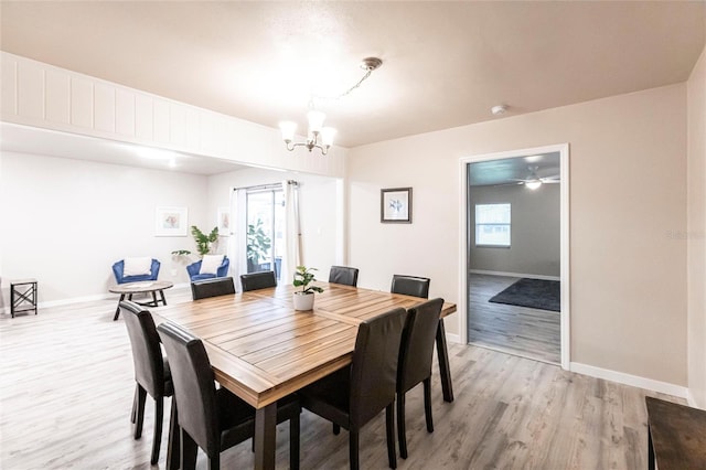 104 Shoreland Dr, Osprey, FL 34229 - dining room featuring baseboards, a notable chandelier, and light wood-style floors