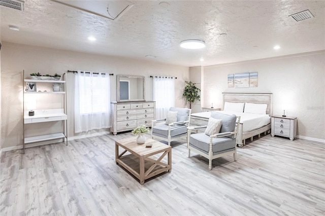 104 Shoreland Dr, Osprey, FL 34229 - bedroom with attic access, baseboards, a textured ceiling, and visible vents