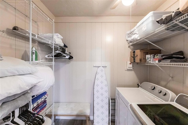 104 Shoreland Dr, Osprey, FL 34229 - clothes washing area featuring washing machine and clothes dryer, a ceiling fan, wood finished floors, and laundry area