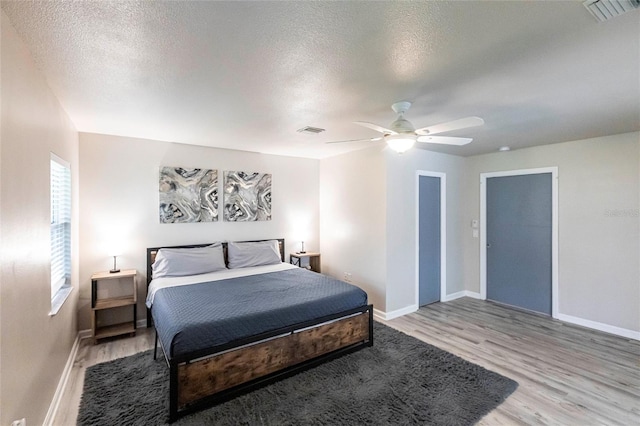 104 Shoreland Dr, Osprey, FL 34229 - bedroom with baseboards, light wood-style floors, and visible vents