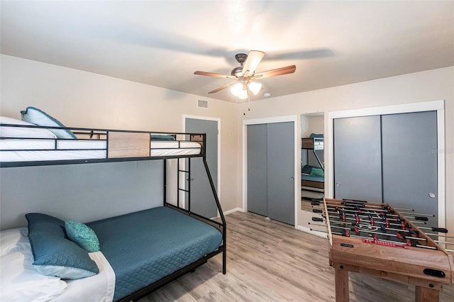 104 Shoreland Dr, Osprey, FL 34229 - bedroom with ceiling fan, wood finished floors, and two closets