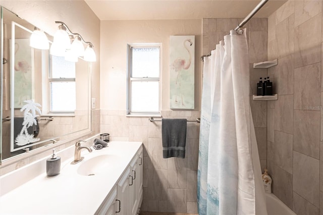 104 Shoreland Dr, Osprey, FL 34229 - bathroom featuring vanity, a wainscoted wall, and tile walls