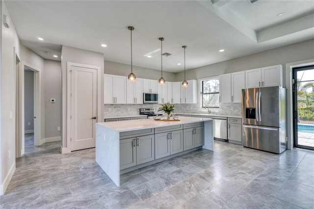 22 Medalist Cir, Rotonda West, FL 33947 - kitchen with stainless steel appliances, a wealth of natural light, light countertops, and decorative backsplash