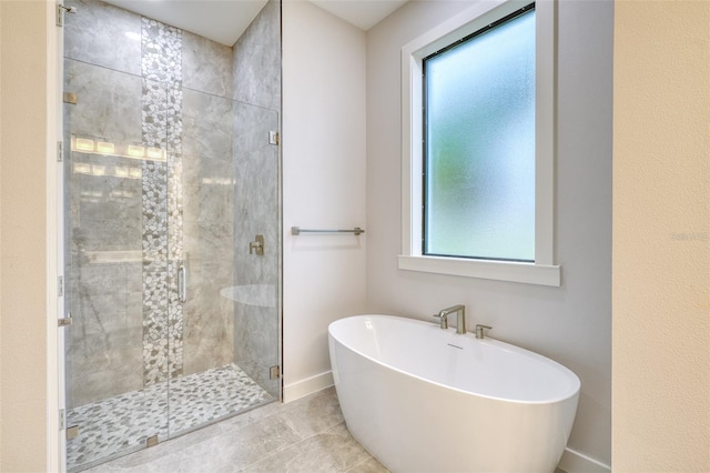 22 Medalist Cir, Rotonda West, FL 33947 - full bathroom featuring a stall shower, tile patterned flooring, a freestanding tub, and baseboards